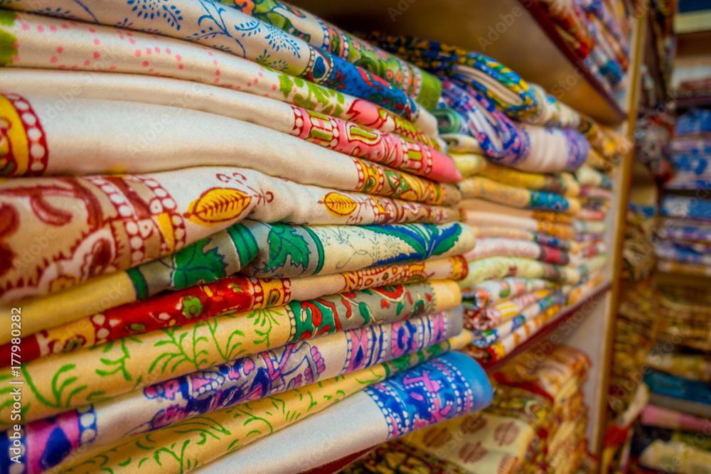 Close up of Indian traditional women ari clothes on Market., colorful beautiful dresses in the Store. Luxury Oriental Handmade Eastern Fabric