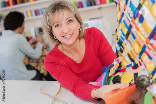 Woman showing sewn handicraft