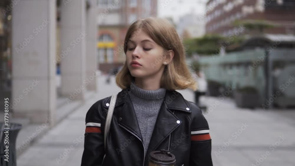young girl uses a smartphone and drinks coffee young girl uses a smartphone and drinks coffee