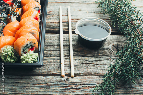 on a wooden table lay in the black sushi container photo