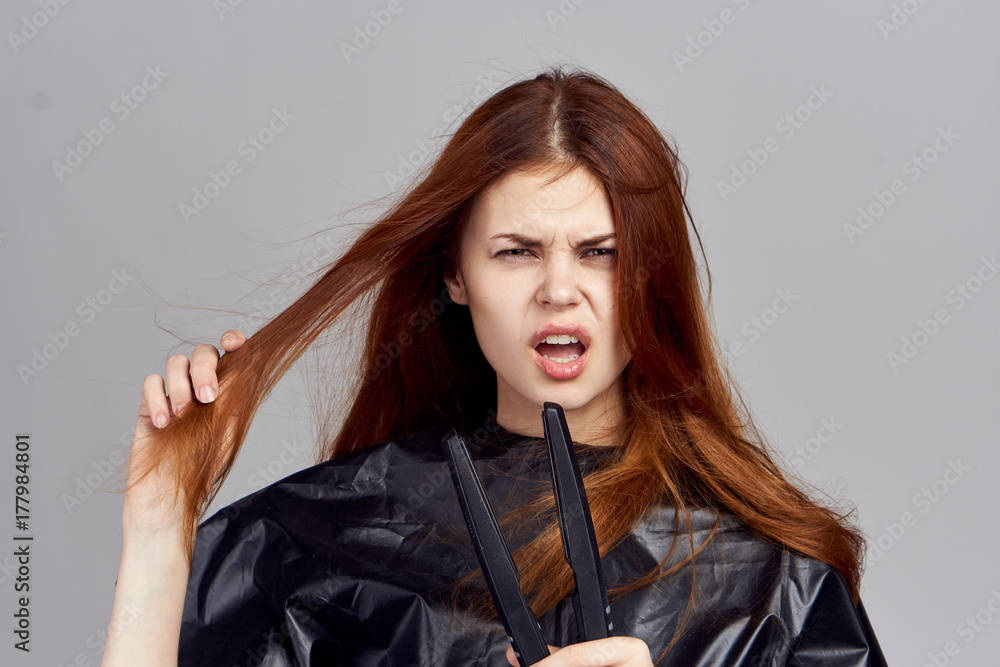Fototapeta premium the red hairdresser in black did not work with hair folks and she is somewhat unhappy with this fact