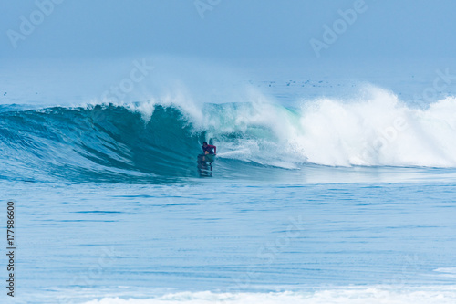 Bodyboarder surfing ocean wave © homydesign