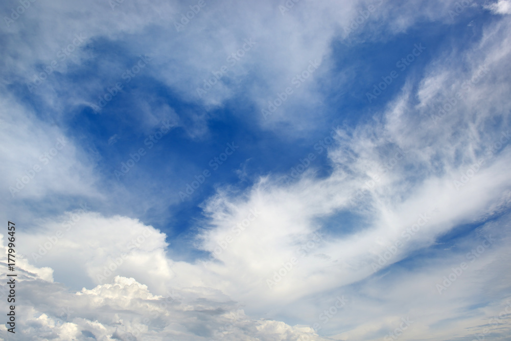 White clouds on a background of dark blue sky.