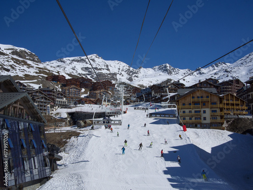 Val Thorens, France _ March  18, 2017: Ski slope and chairlift in Val Thorens, people skiing in the middle of the village photo