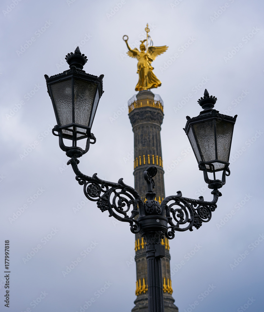 Victory Column Siegessäule in Berlin behind street lamps