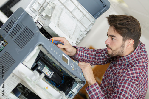 hold a screwdriver for fixing printer