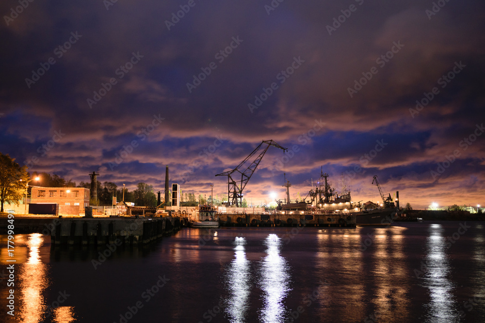 Trade port in dark gloomy late evening in Kronstadt, Russia