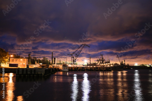 Trade port in dark gloomy late evening in Kronstadt, Russia