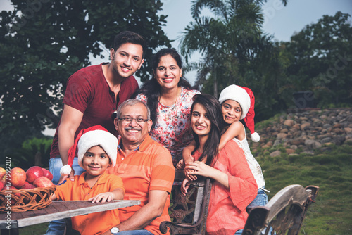 Photography Indian family celebrating christmas and posing for a group photo