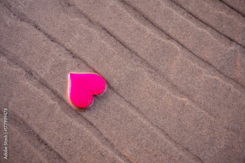 love symbol of heart on the sea beach photo