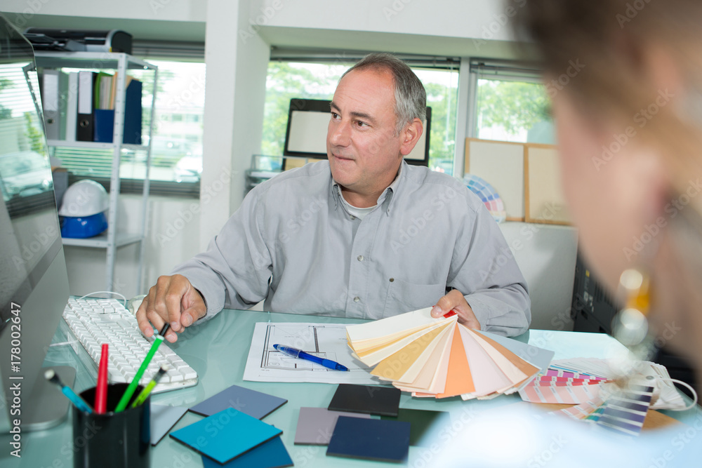 man choosing color swatches