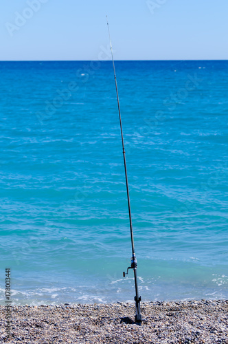 Fishing rod on a pebbly beach