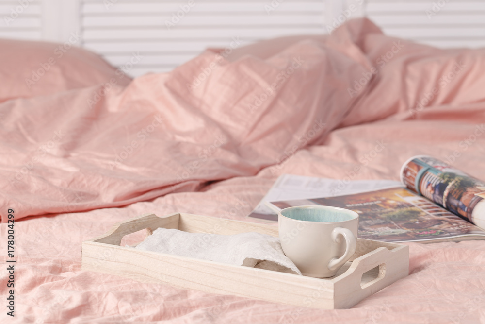 Wooden tray with tasty breakfast on bed Wooden tray with tasty breakfast on bed