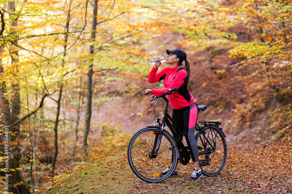 Fototapeta premium Young active sport girl with bicycle outdoor
