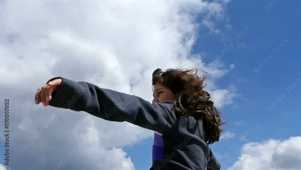 Little girl high in the mountain with raised arms, slow motion Little girl high in the mountain with raised arms, slow motion