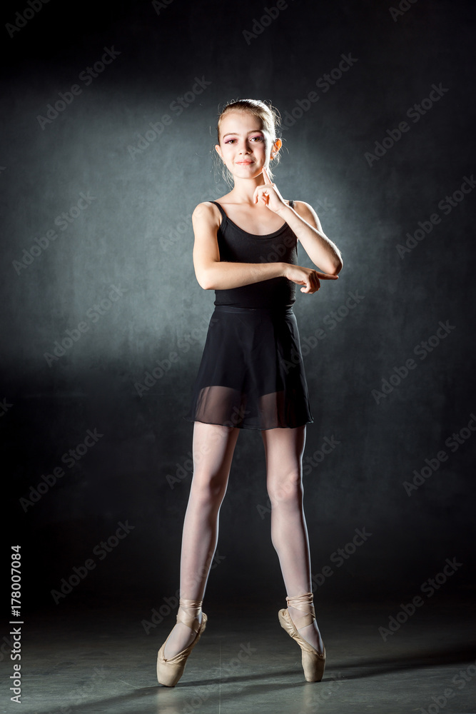 Ballet. Image of a flexible cute ballerina dancing in the studio. Beautiful young dancer. Little black dress. Ballet. Image of a flexible cute ballerina dancing in the studio. Beautiful young dancer. Little black dress.