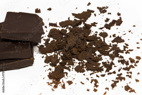 Chocolate cubes, pieces of bitter, dark chocolate bar, isolated on white background.