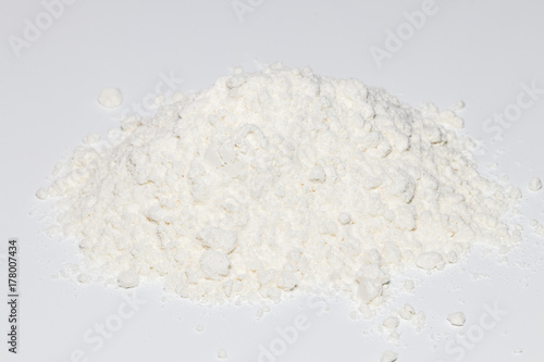 Pile of wheat flour isolated on white background