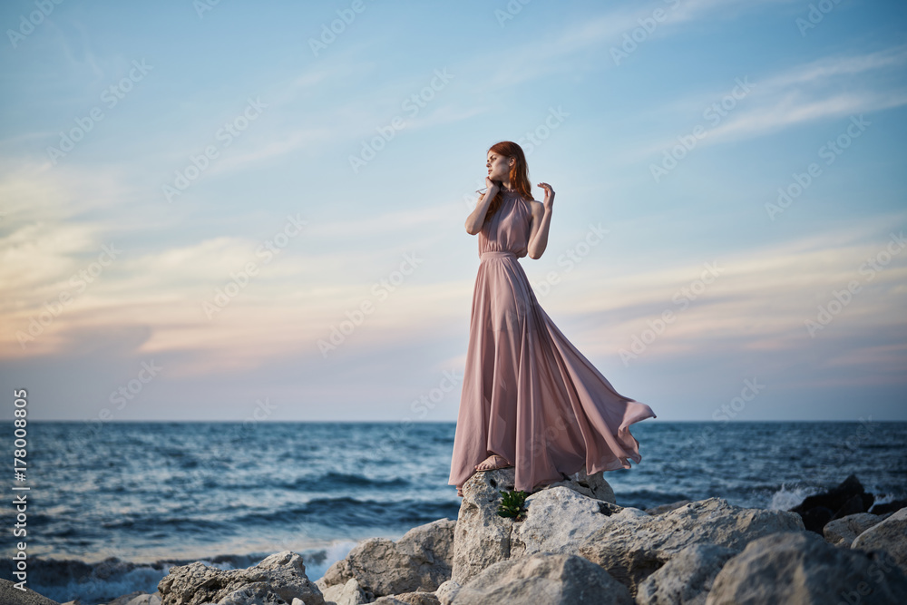 beautiful woman in a dress on the coast by the sea, nature beautiful woman in a dress on the coast by the sea, nature