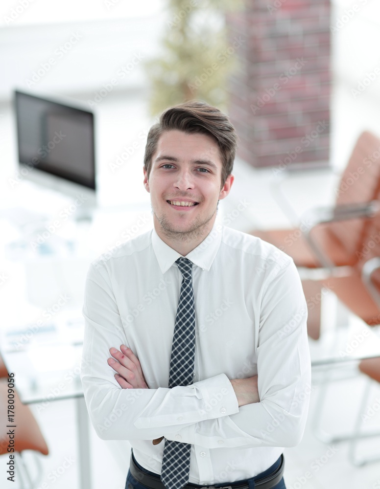 confident young businessman on background of office confident young businessman on background of office