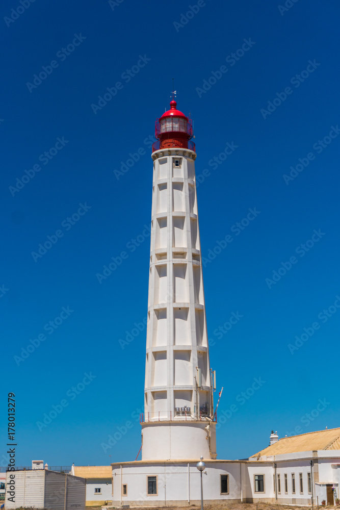 Lighthouse on the sea under blue sky on summer time Lighthouse on the sea under blue sky on summer time