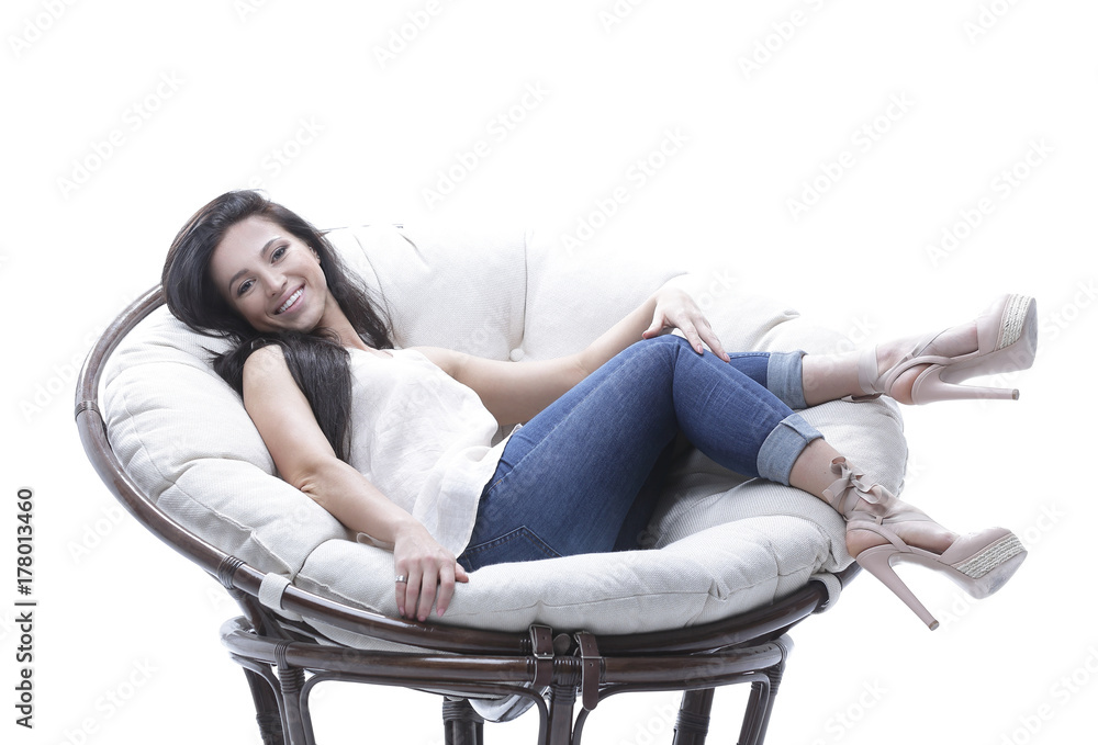 modern young woman relaxing in a round cozy soft chair. modern young woman relaxing in a round cozy soft chair.