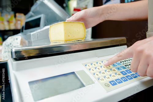 Weighing cheese on electronic scales