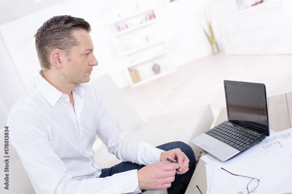 pensive businessman working with laptop indoors pensive businessman working with laptop indoors
