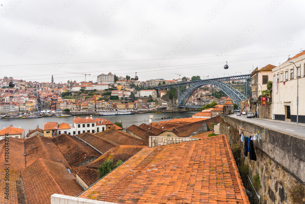 View on Vila Nova de Gaia on Douro river in Porto, Portugal. British wine and port cellars - popular touristic attraction and destination for wine and port tasting with tours and excursions.