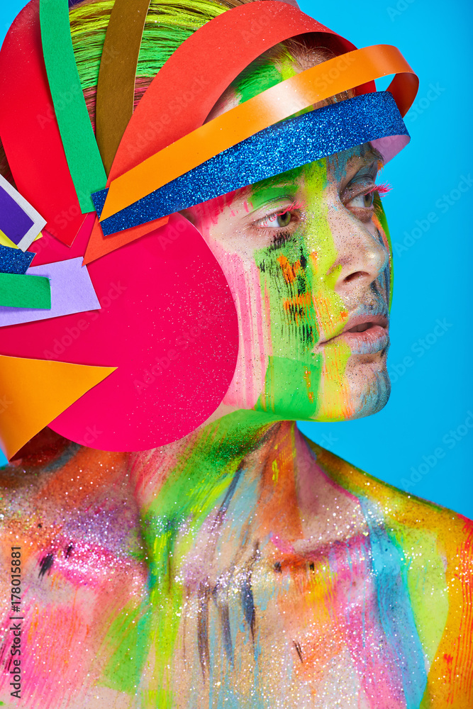 Obraz premium Model with colorful abstract makeup in multicolored helmet
