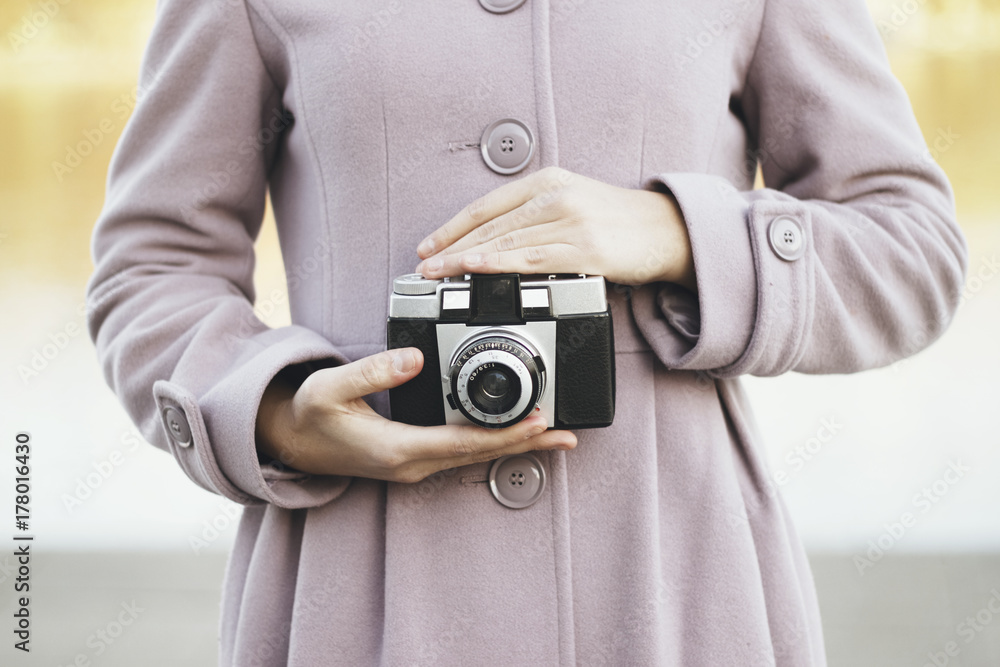 Young woman with a retro camera Young woman with a retro camera