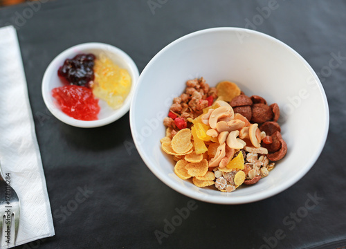 Cereals with fruits and nuts served with jam. Healthy food concept.