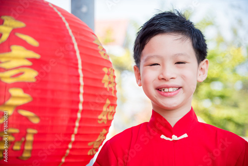 Young chinese boy wearing traditional dress smiling outdoor