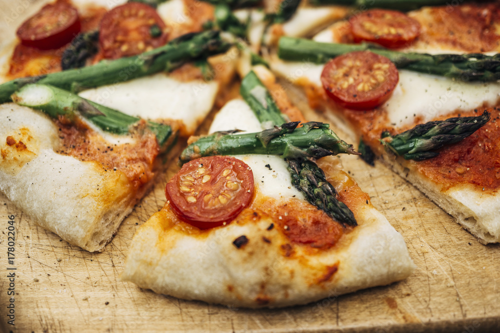 Food: Homemade Pizza with green asparagus and cherry tomato Food: Homemade Pizza with green asparagus and cherry tomato