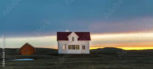Norwegian beautiful house lit by the midnight sun photo