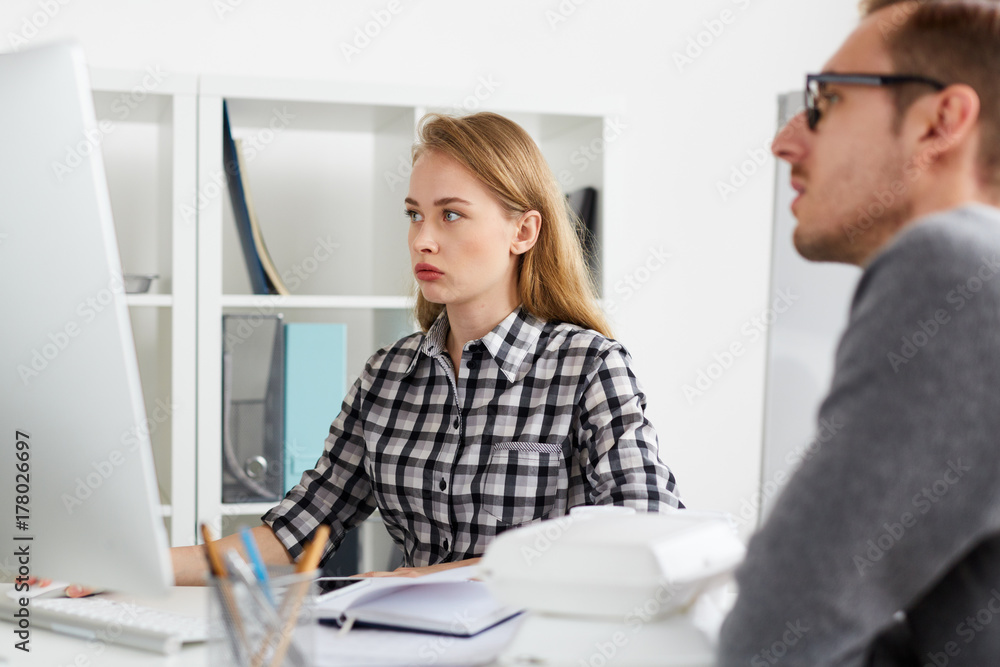 Two office workers browsing in the net or analyzing data Two office workers browsing in the net or analyzing data