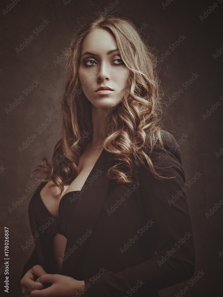 Fototapeta premium Sexy beauty. Positive expressed young woman posing for camera, studio female portrait