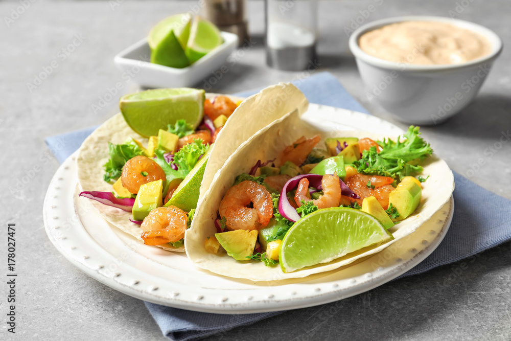 Plate with delicious shrimp tacos on table Plate with delicious shrimp tacos on table