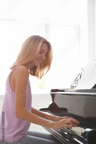 Talented woman playing pian...