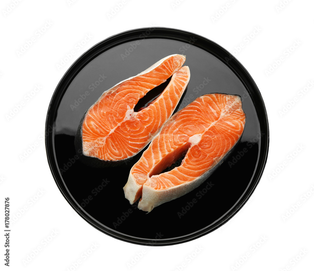 Plate with fresh salmon steaks on white background Plate with fresh salmon steaks on white background
