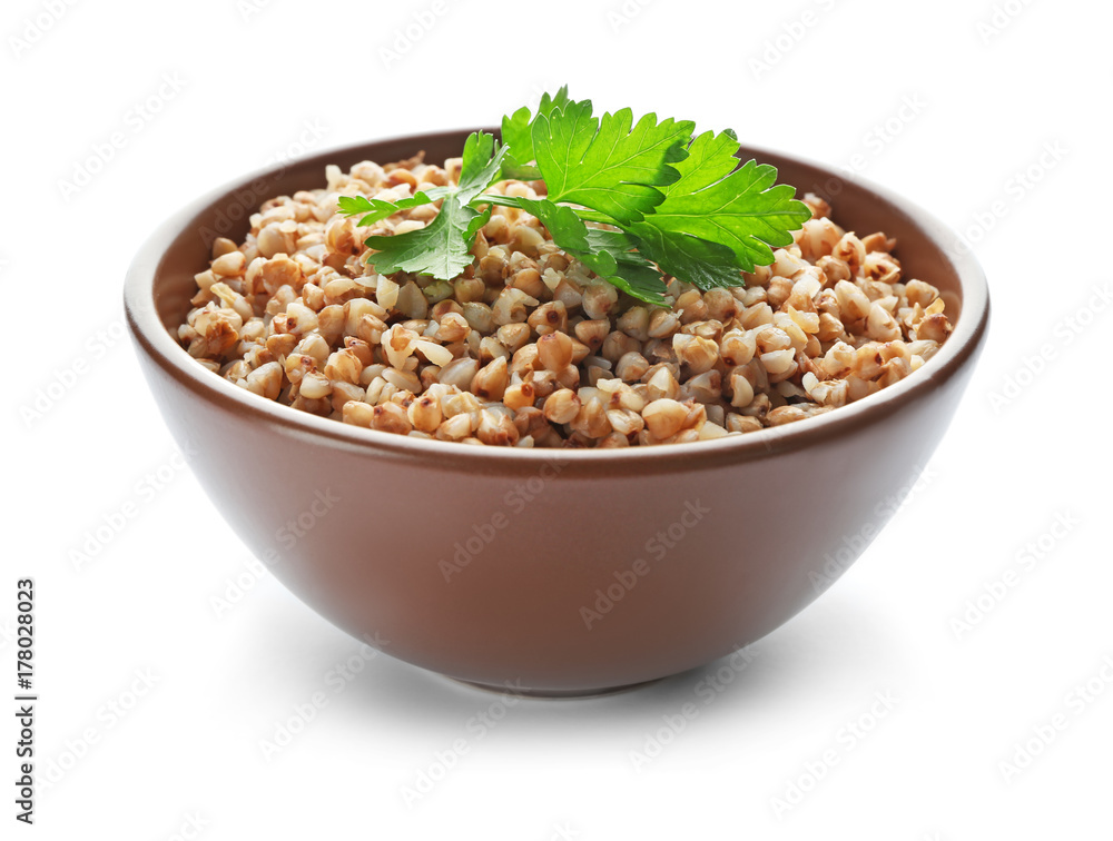 Bowl with cooked buckwheat on white background Bowl with cooked buckwheat on white background