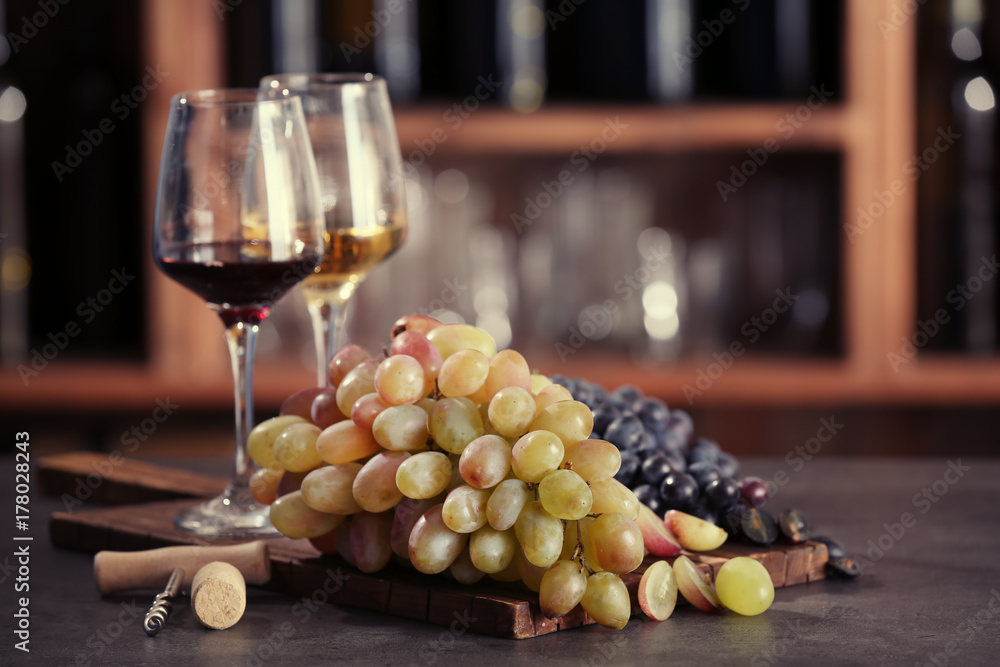 Composition with wine and grapes on table