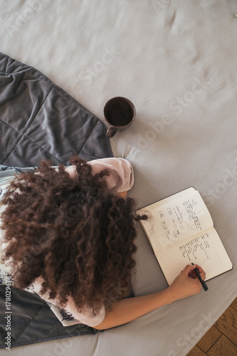 Woman writing in her diary photo