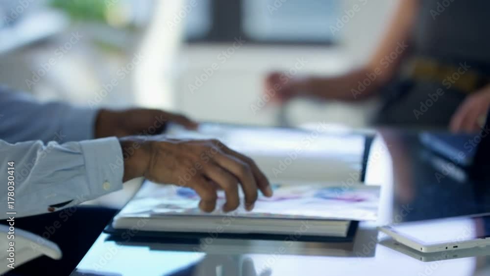 custom made wallpaper toronto digitalBusiness man and woman in a meeting looking at printed graphs and discussing