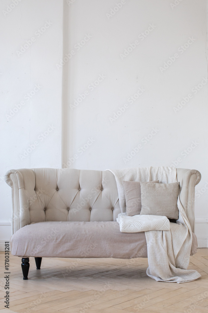Vertical indoors shot of light interior with small couch. Vertical indoors shot of light interior with small couch.