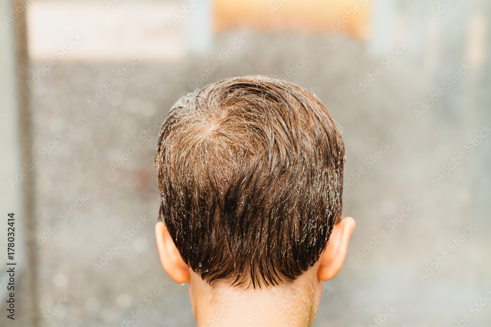 boy with wet hair standing in mist boy with wet hair standing in mist