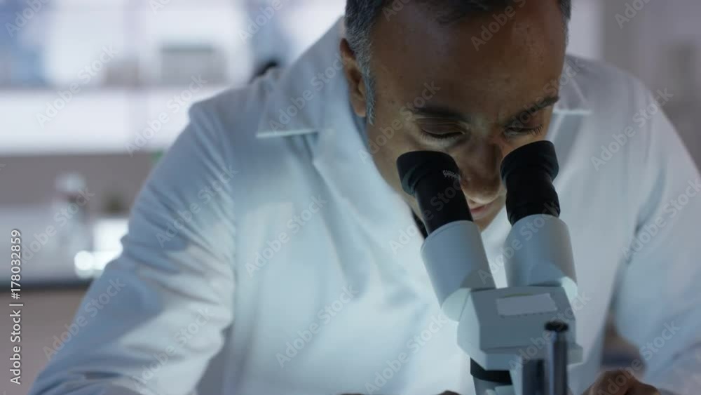 Medical researchers working in the lab analyzing samples and discussing Medical researchers working in the lab analyzing samples and discussing