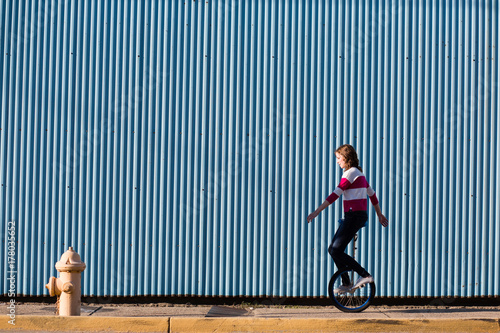 teen riding unicycle photo