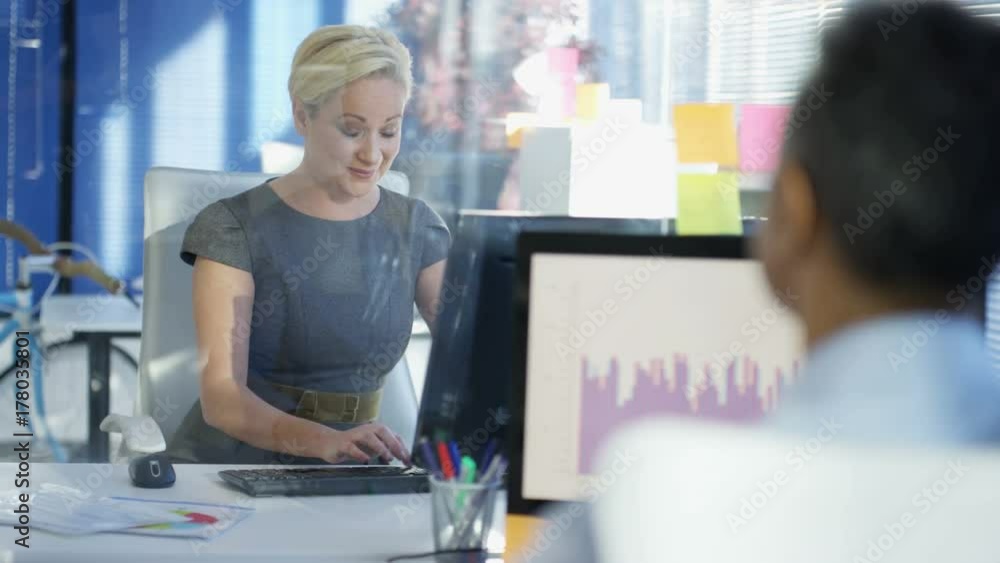 Business man and woman chatting and analyzing financial data in corporate office Business man and woman chatting and analyzing financial data in corporate office