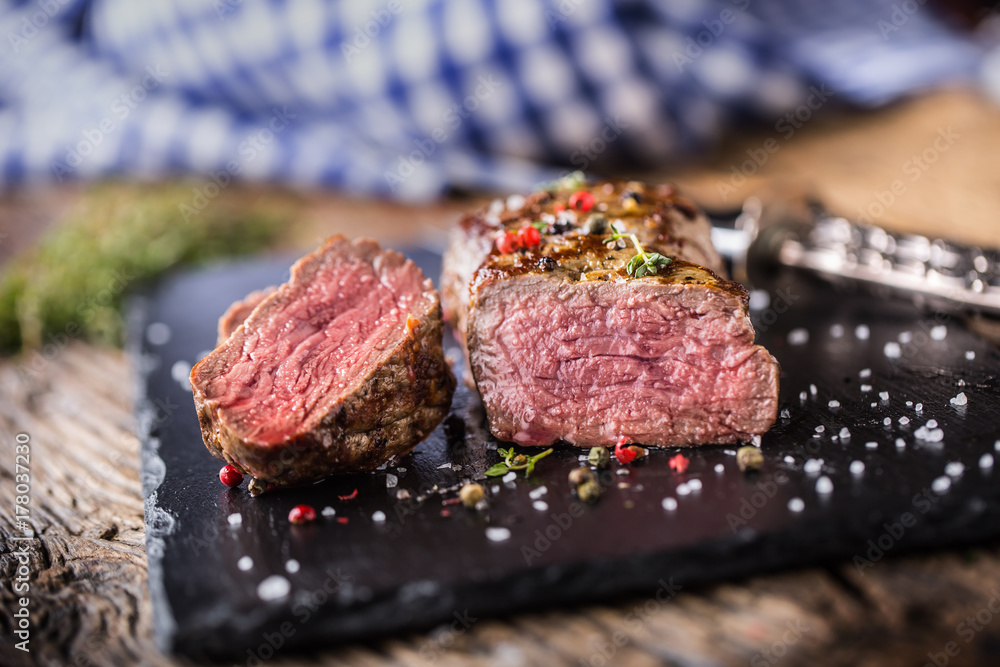 Beef Steak. Roasted Beef steak with salt pepper thyme on rustic wooden table Beef Steak. Roasted Beef steak with salt pepper thyme on rustic wooden table